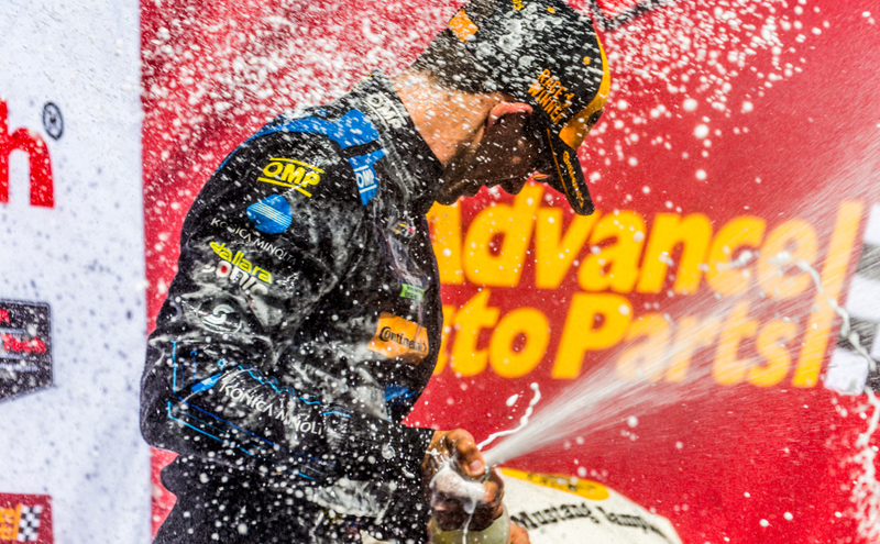 Wayne Taylor Racing driver Jordan Taylor, spraying champagne. Photo credit: Kurt Bradley